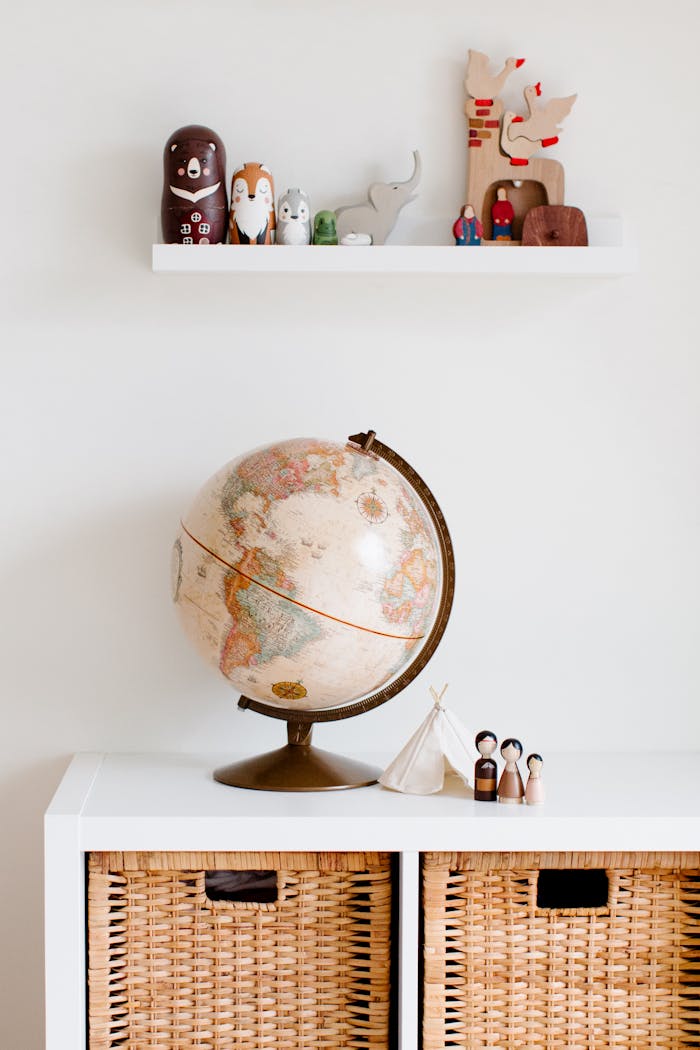 who-we-are Cozy children's room with globe and toys, blending modern and vintage decor styles.